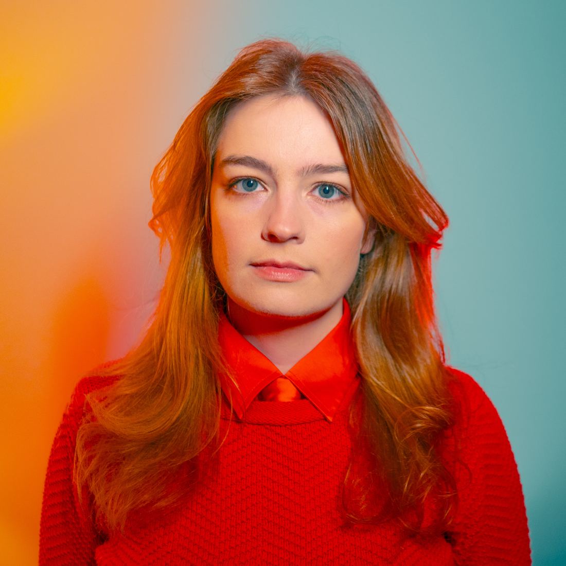 Studio portrait of Shannon McNeal in a red sweater